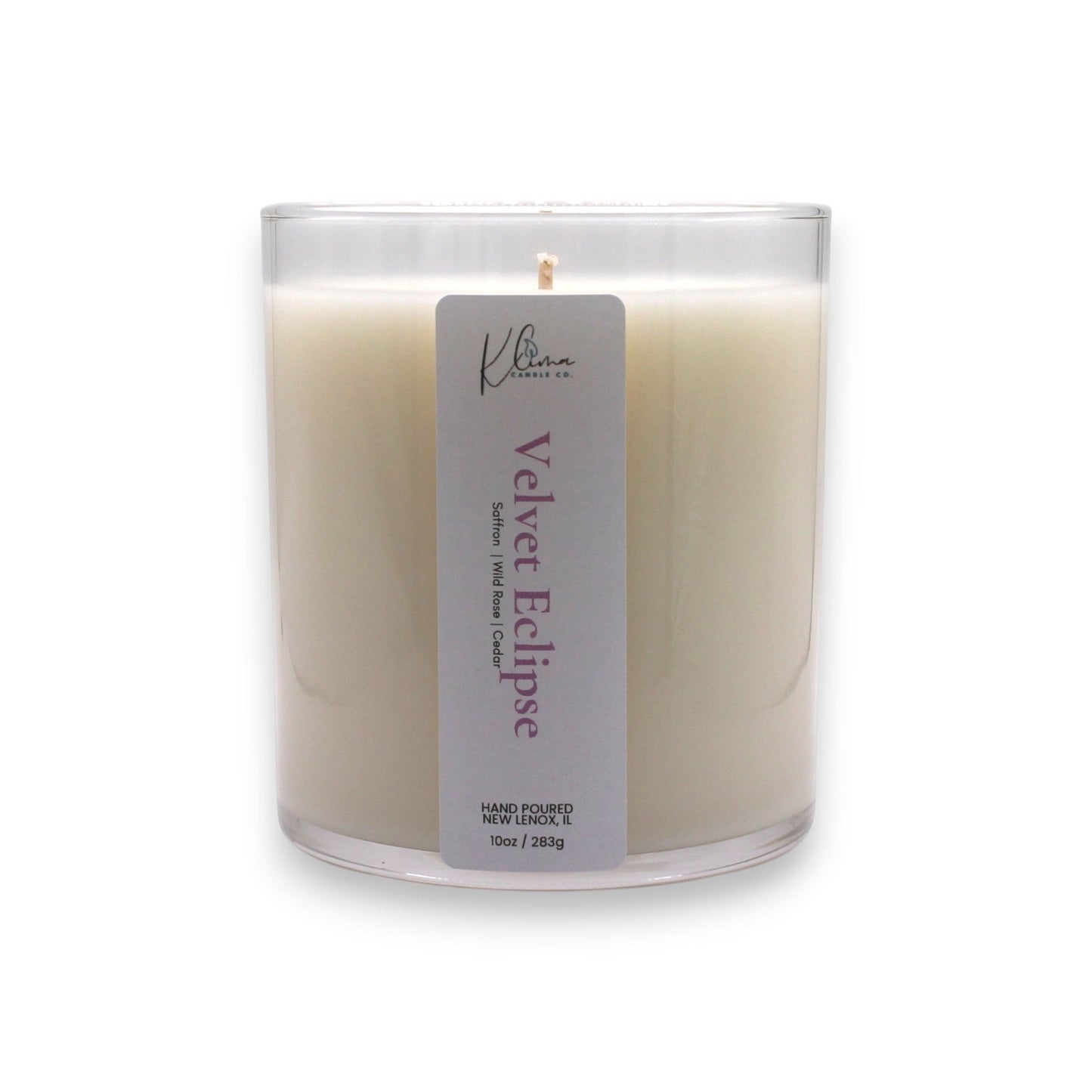 Klima Candle Co. Velvet Eclipse candle in a clear glass jar with a light cream wax. Scent notes: Saffron, Rose, Cashmere Musk.